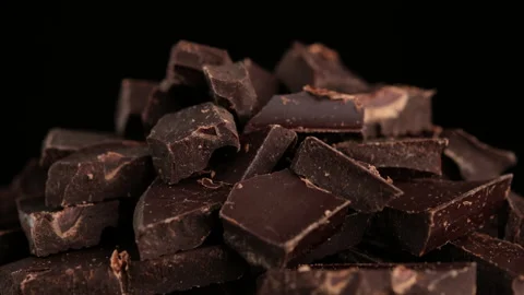 Chocolate. Chunks of dark chocolate rotate on dark background, rotate Stock-Footage 160346972
