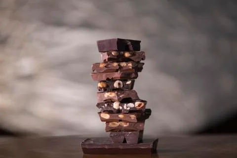 Chocolate chunks with nuts forming a tower Stock Photos