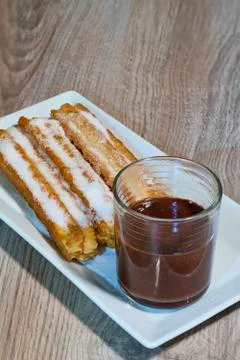 Chocolate with churros on rectangular plate 写真素材