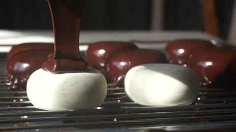 Chocolate coating is poured on the cake Stock Footage 62812250