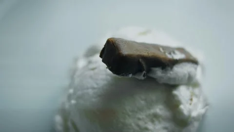 Chocolate cookie resting over a mound of vanilla ice cream, 4K Stock Footage 341119448