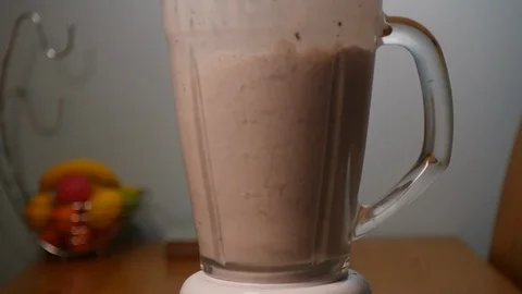 Chocolate cookie smoothie being made in a blender in slow motion Stock Footage 121449402