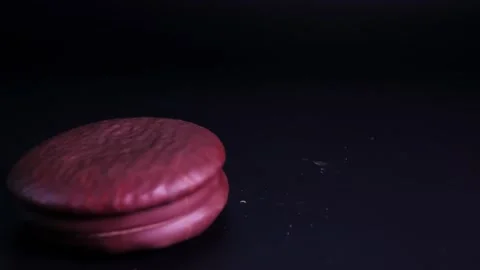 Chocolate cookies falling slowly onto the table surface Video stock 282525507