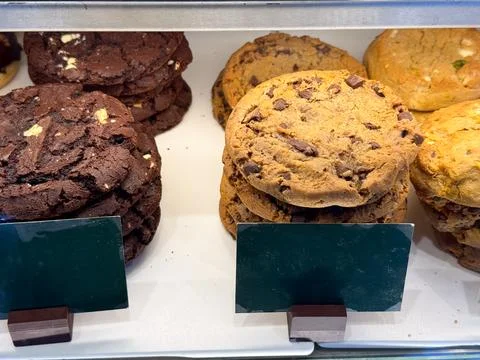 Chocolate cookies stack and bakery biscuits in showcase. Sweet snack, dessert 스톡 사진
