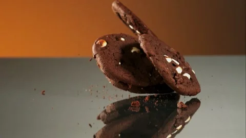 Chocolate cookies stacking on a reflective surface Stock Footage 327122843