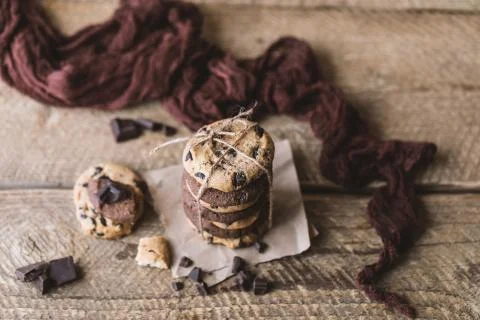 Chocolate cookies on wooden rustic table. Homemade cookies. Stack of tasty choco Stock Photos
