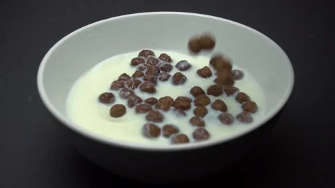 Chocolate Corn Balls Falls In Milk. Slow Motion. Camera zoom Stock Footage 86995618