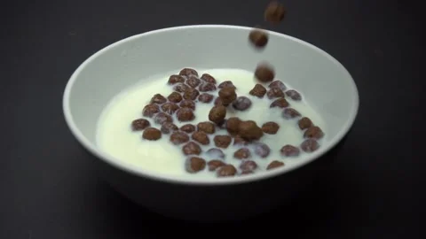 Chocolate Corn Balls Falls In Milk. Slow Motion. Stock Footage 86995760