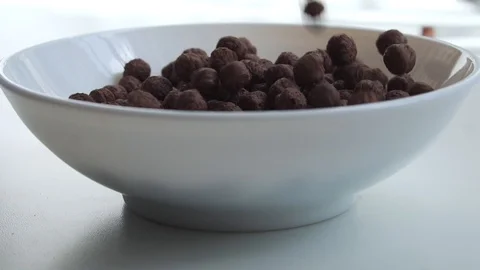 Chocolate corn flakes falling into the bowl. Stock Footage 129234733