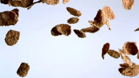 Chocolate cornflakes falling against white background in slow motion Stock Footage 81215019
