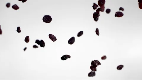 Chocolate cornflakes falling against white background in slow motion Video stock 81231264