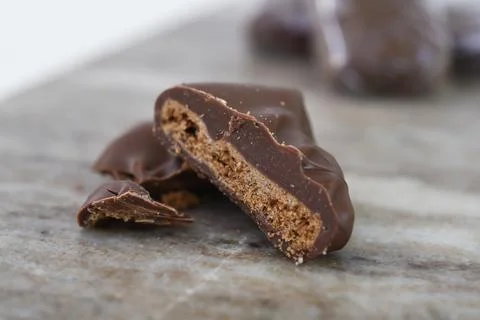 Chocolate Covered Biscuit Piece, broken in half to clearly show its texture.. Stock Photos