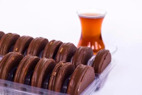 Chocolate covered biscuits lined up in a transparent box Stock Photos