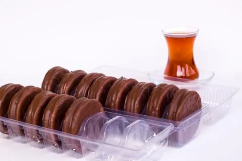 Chocolate covered biscuits lined up in a transparent box Stock Photos