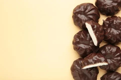 Chocolate covered marshmallows on beige background with copy space. Minimalis Stock Photos