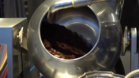 Chocolate covered nuts are mixed in a special drum. Chocolate Factory. Stock Footage 153162051
