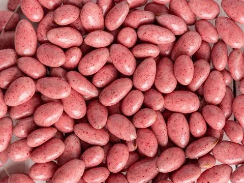 Chocolate-covered nuts in close-up. Background, texture. Lots of delicious .. Stock Photos