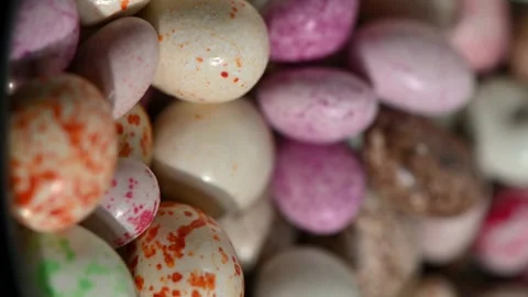 Chocolate covered peanuts with glossy glaze rotating on black background. 스톡 동영상 328636597