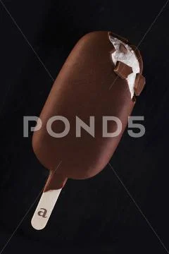 A chocolate covered vanilla ice cream stick Stock Photos