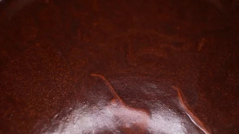 Chocolate cream closeup texture video on rolling rotating looping plate Stock Footage 104331176