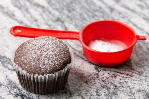 Chocolate cup cake with powdered sugar on the grey granite background Stock Photos