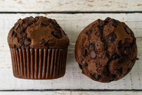 Chocolate cupcake with chocolate drops. Rustic wood background Stock Photos