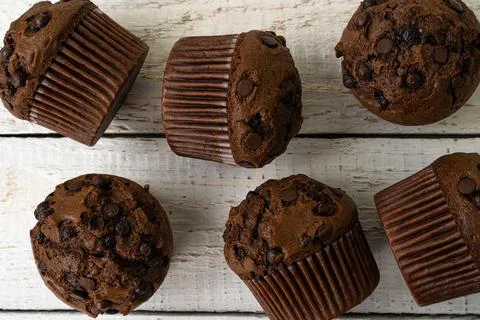 Chocolate cupcake with chocolate drops. Rustic wood background Stock Photos