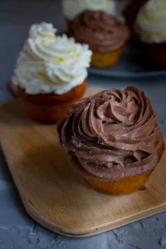Chocolate cupcake on a kitchen board, vertical photo Stock Photos