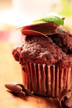 Chocolate cupcake with mint leaf decoration Stock Photos