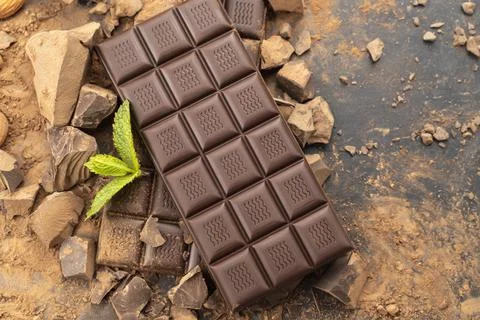 Chocolate. dark chocolate bar stack and cocoa powder with mint leaf Stock Photos