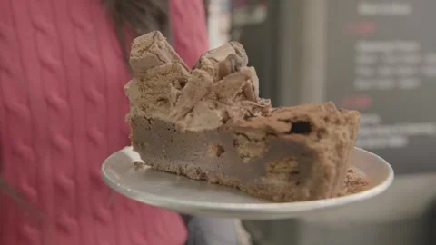 Chocolate Dessert Pie Slice Held by Hand in Sydney Cafe Interior Stock Footage 345666749