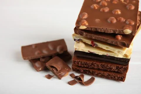 Chocolate of different types on a colored background with a place for text Stock Photos