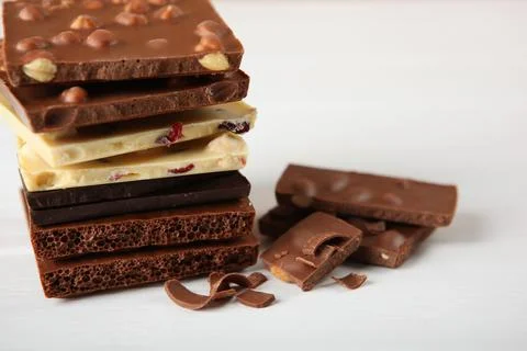 Chocolate of different types on a colored background with a place for text Stock Photos