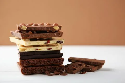 Chocolate of different types on a colored background with a place for text Stock Photos