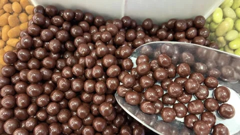 Chocolate dipped glazed balls on a rustic rough burlap. Sweet round candies with Stock Footage 310421352