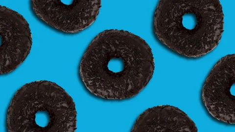 Chocolate donuts pattern on a blue background. Simple motion graphics seamless Stock Footage 150362324