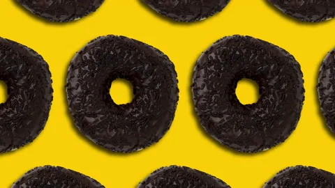 Chocolate donuts pattern on a yellow background. Simple food motion graphics Stock Footage 148996217