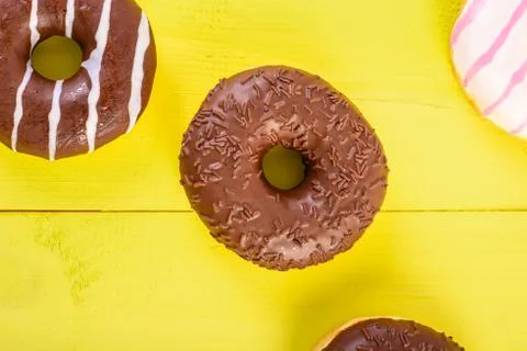 Chocolate Donuts On Yellow Background Stock Photos