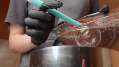 Chocolate dough is put into a baking dish Stock Footage 153462163