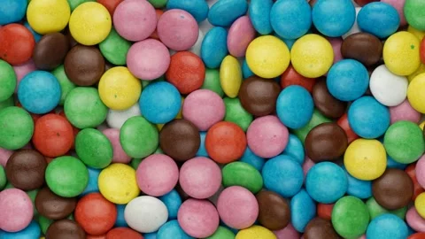 Chocolate dragees - background. Multicolored dragees, top view. Video stock 148975377