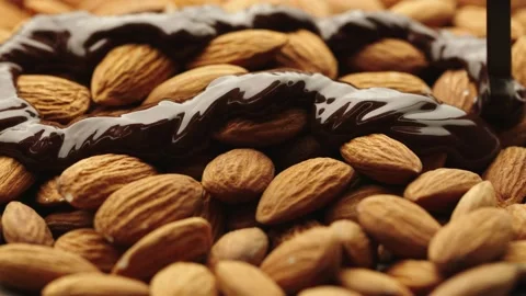 Chocolate drips onto almonds Stock Footage 161077223