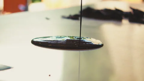 Chocolate drizzled onto counter top Stock Footage 274635900