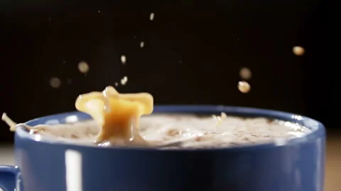 Chocolate dropping into coffee mug (Close up) (Slowmo) Stock Footage 162671359