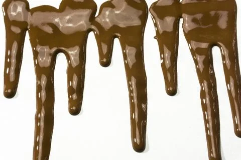 Chocolate   dropping or dripping on background Stock Photos
