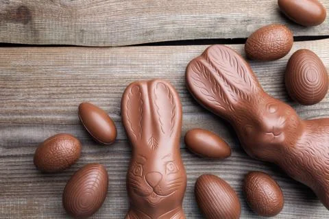 Chocolate Easter bunny and eggs on wooden background Stock Photos