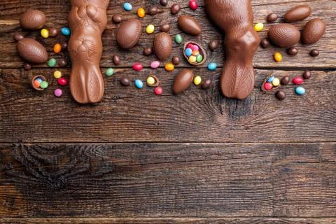 Chocolate Easter bunny and eggs on wooden background Stock Photos