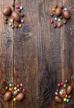 Chocolate Easter bunny and eggs on wooden background Stock Photos