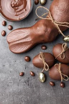 Chocolate Easter bunny and eggs on wooden background Stock Photos