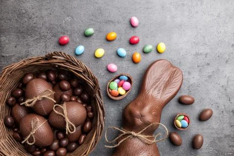 Chocolate Easter bunny and eggs on wooden background Stock Photos