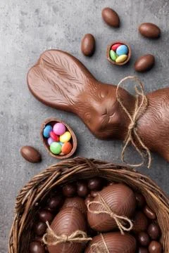 Chocolate Easter bunny and eggs on wooden background Stock Photos